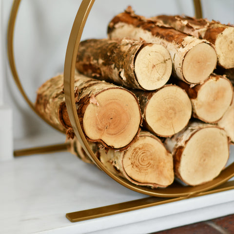 Side View Of Brass Finish Log Rack With Logs In Situ